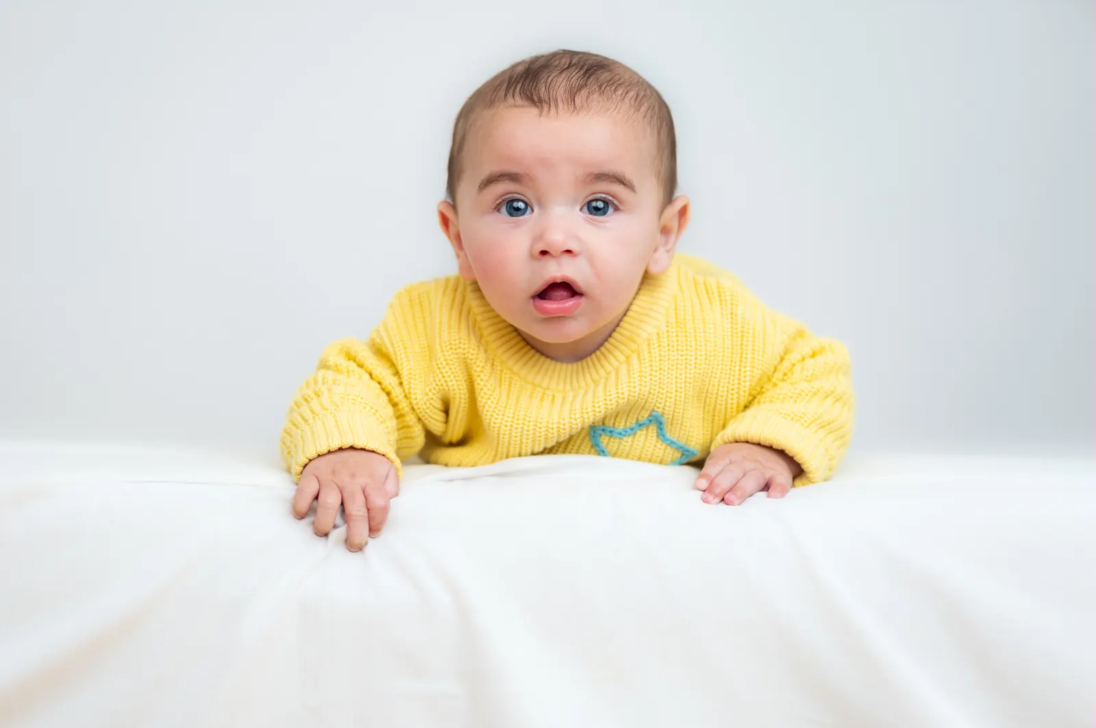 Baby in yellow sweater