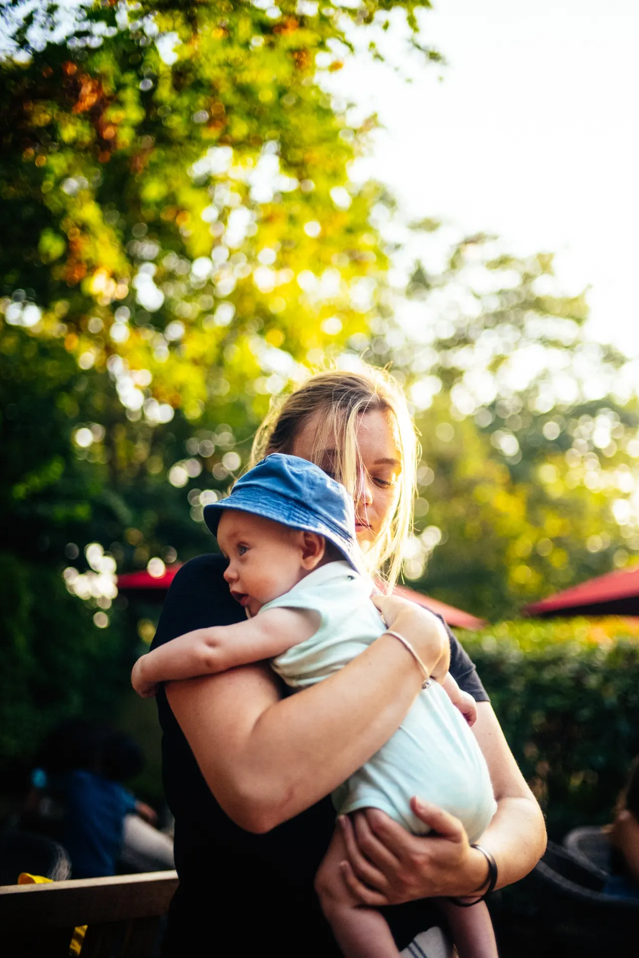 Mother holding baby in evening sunlight