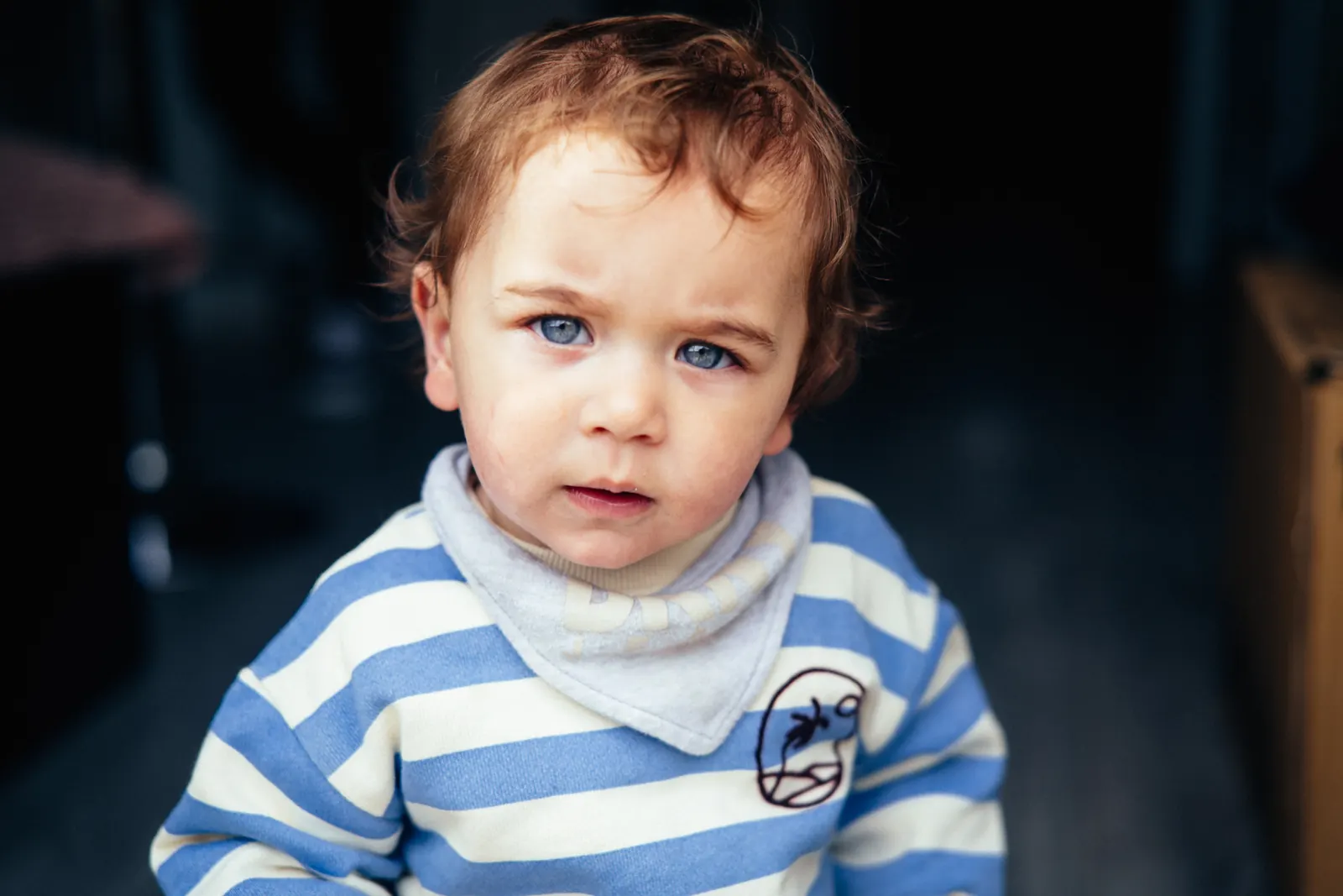 Toddler with red curls in striped top