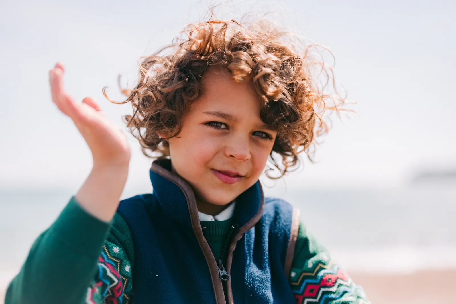 Curly-haired boy on the beach