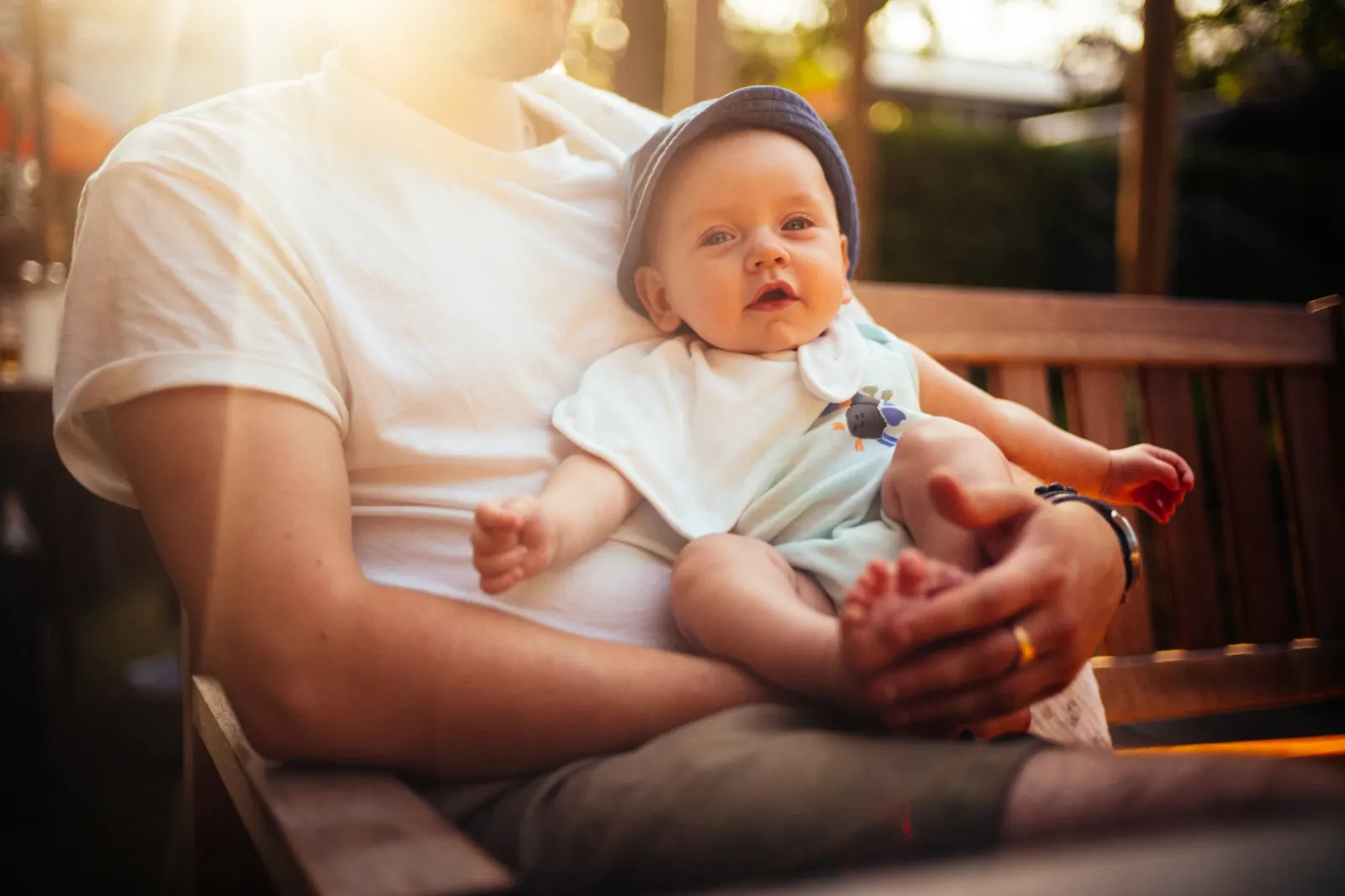 Father holding baby in golden hour sunlight