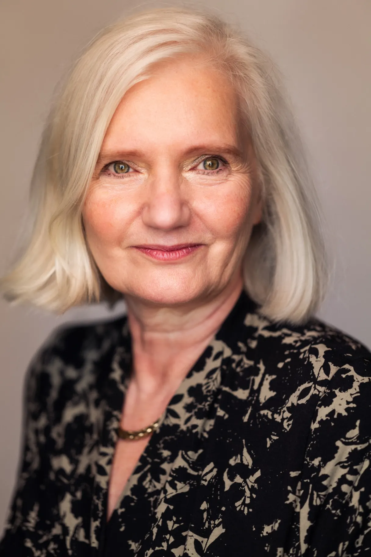 Silver-haired woman studio portrait smiling