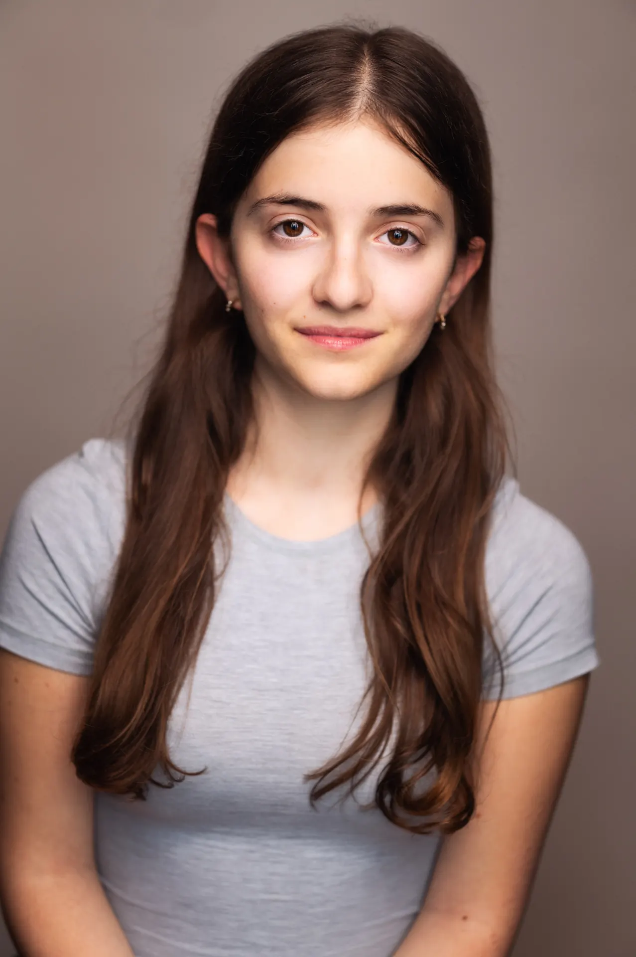 Teenage girl studio portrait with long brown hair