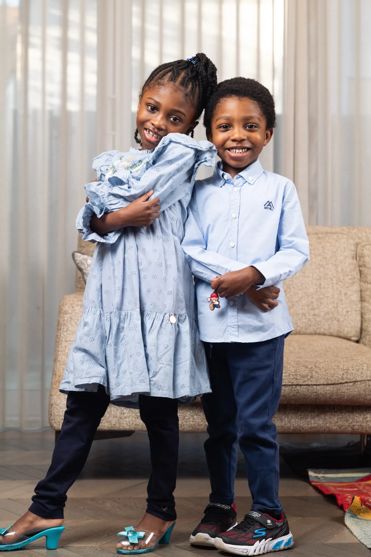 Brother and sister hugging at home