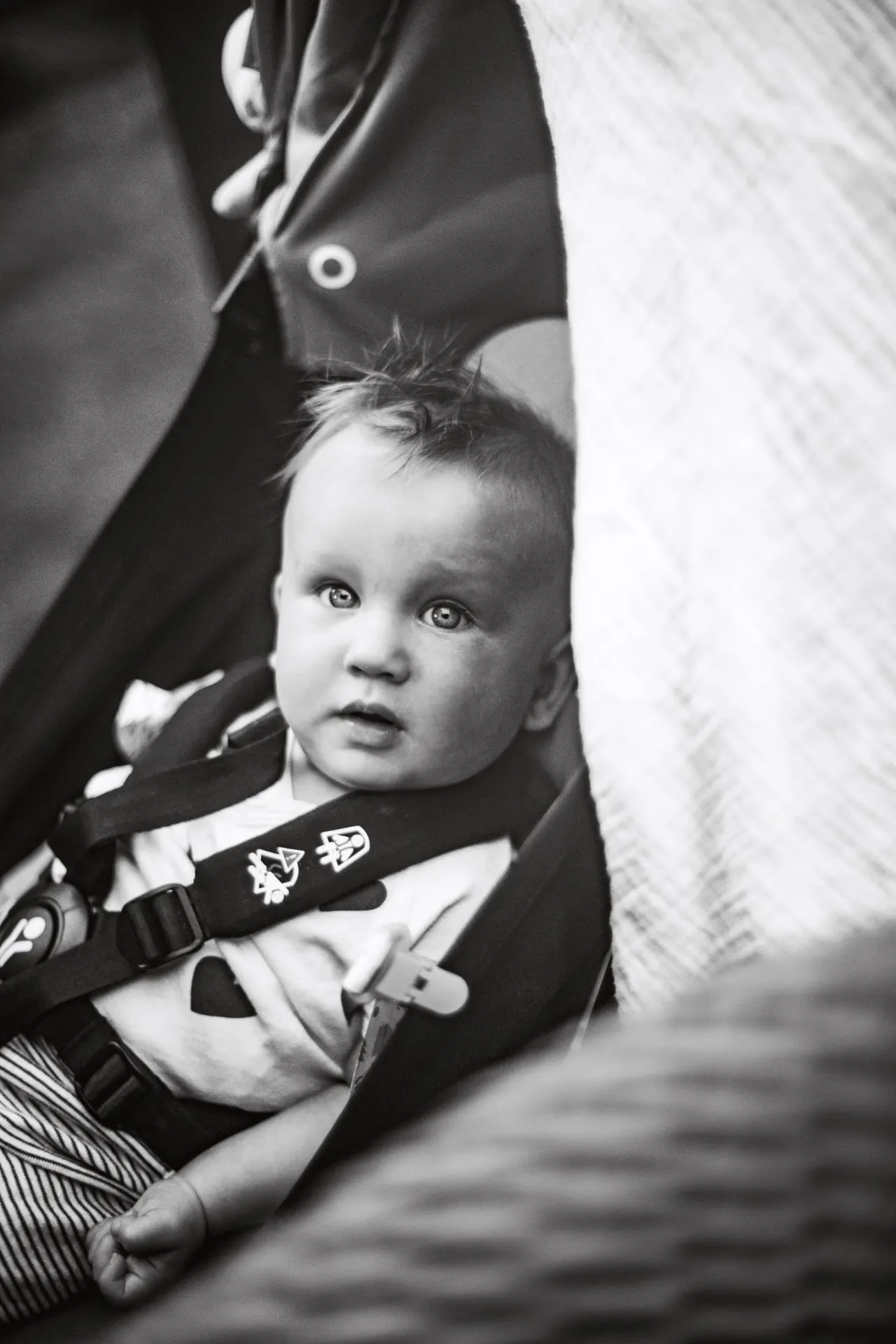 Baby in pushchair, black and white