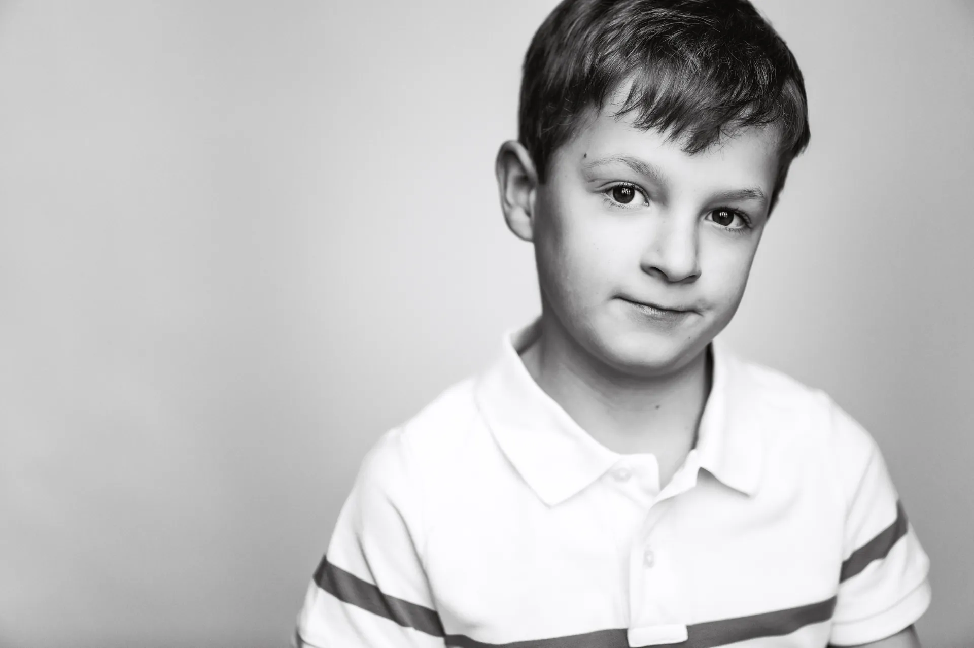 Studio portrait of a young boy in black and white